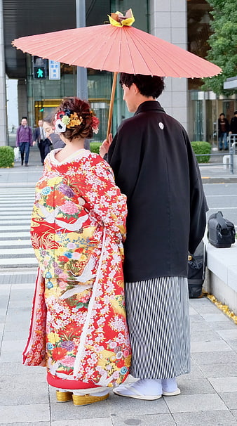 Japanese Wedding Couple in Traditional Attire with Pink Umbrella