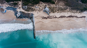 Aerial View of Turquoise Ocean Waves Crashing on Sandy Beach