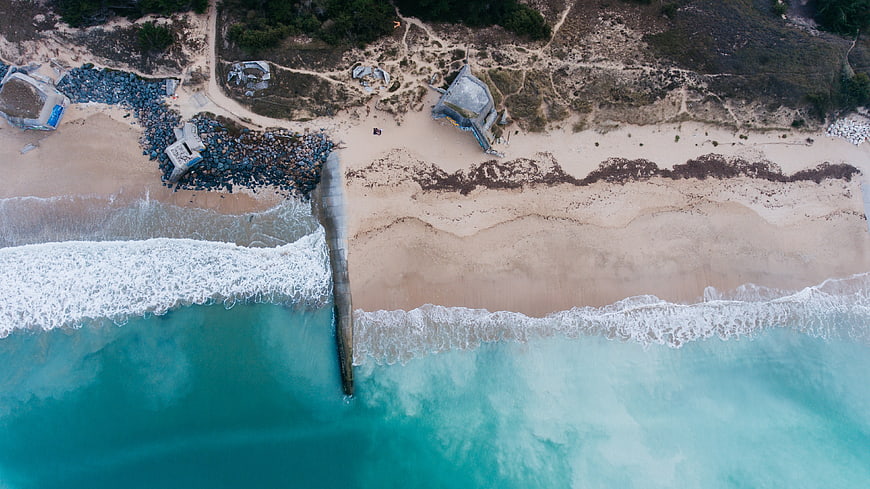 Aerial View of Turquoise Ocean Waves Crashing on Sandy Beach