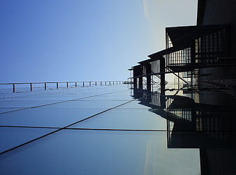 Modern Glass Building Facade with Blue Sky Reflection