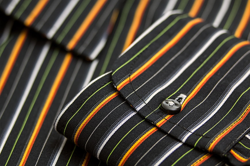 Close-up of striped shirt cuff with button
