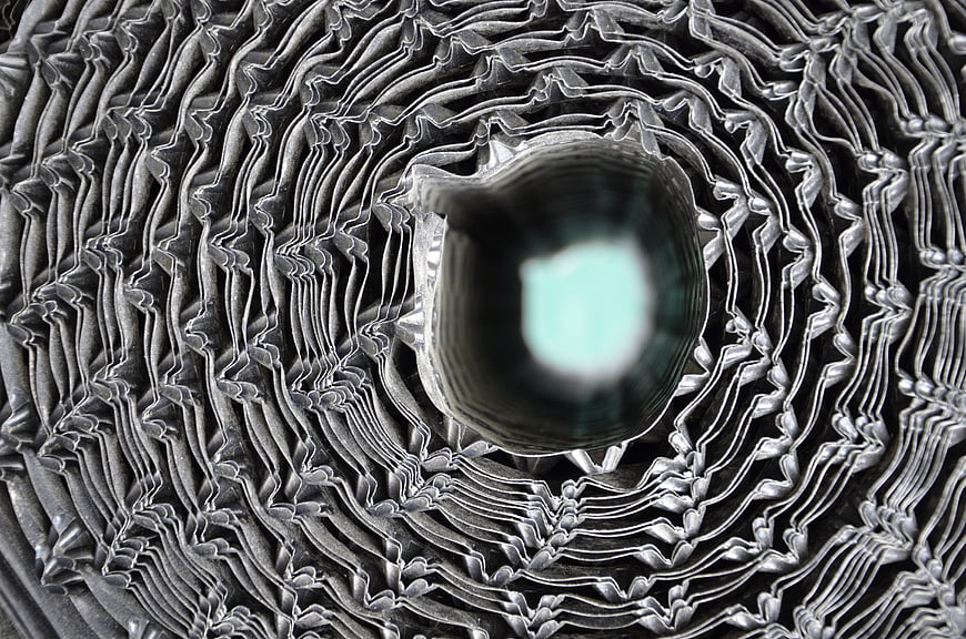 Abstract metallic spiral texture with glowing center