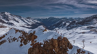 Skiing on Snowy Mountain Ridge with Alpine Panorama