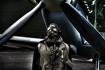 Vintage Pilot in Front of Propeller Aircraft