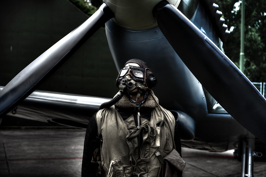 Vintage Pilot in Front of Propeller Aircraft