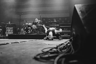 Rock musician headbanging on stage with guitar