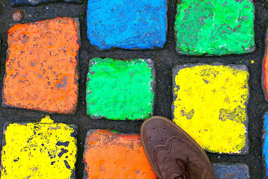 Brown Shoe on Colorful Painted Cobblestones