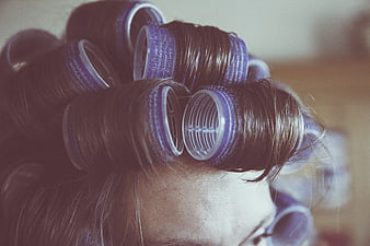 Close-up of woman's hair in purple rollers