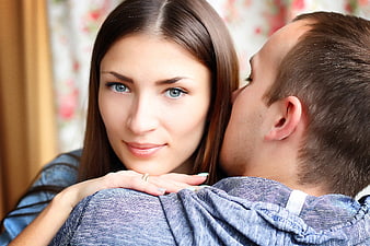 Romantic couple portrait with man kissing woman's cheek