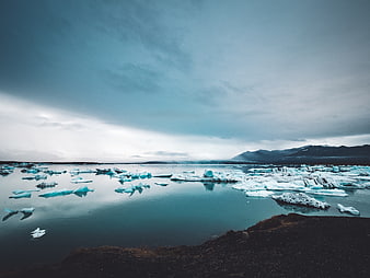 Icelandic Glacier Lagoon with Floating Icebergs and Mountains