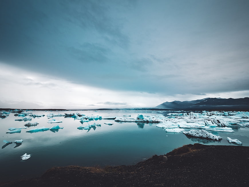 Icelandic Glacier Lagoon with Floating Icebergs and Mountains