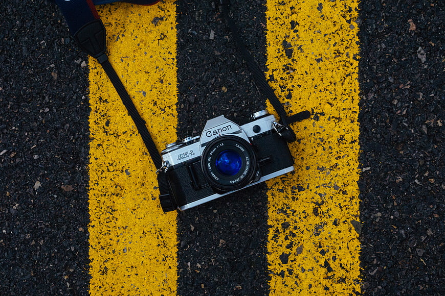 Vintage Canon AE-1 Camera on Yellow Road Lines