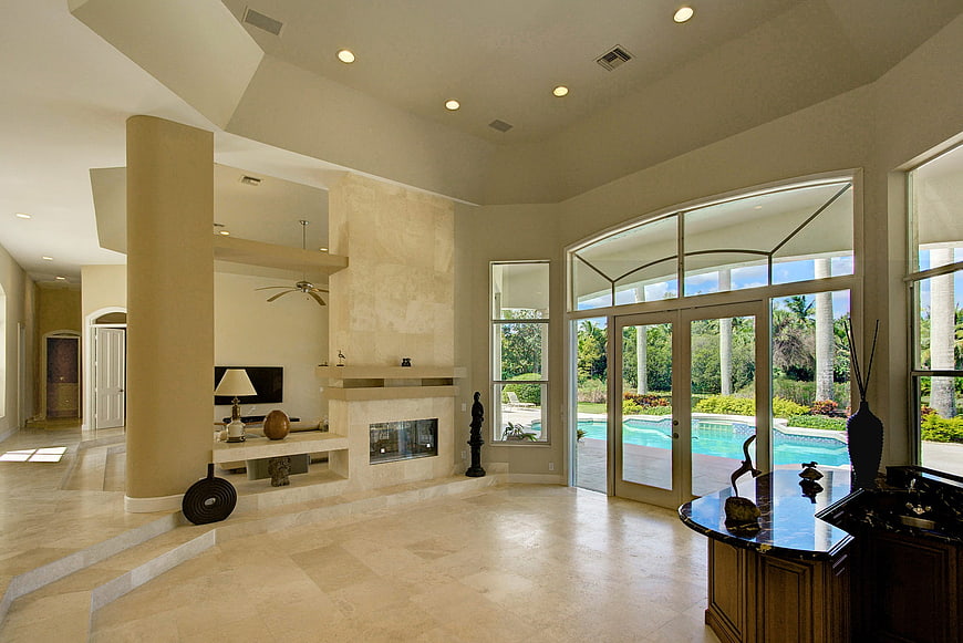 Luxury Living Room with Fireplace and Pool View