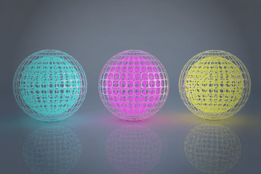Three glowing wireframe spheres in cyan, pink, and yellow