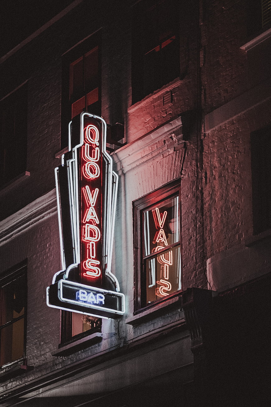 Quo Vadis Bar Neon Sign at Night