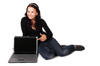 Young woman pointing at laptop screen on white background