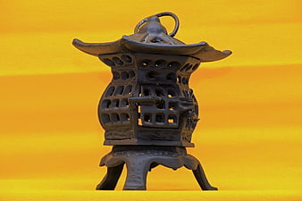 Traditional Asian Incense Burner on Yellow Background