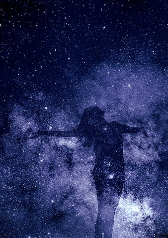 Silhouette of woman with arms outstretched against starry night sky