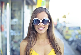 Smiling Woman in Yellow Dress and White Sunglasses on Street