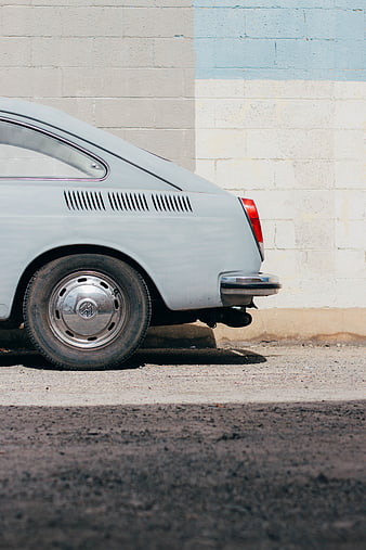 Vintage Volkswagen Sedan Rear Detail Against Brick Wall