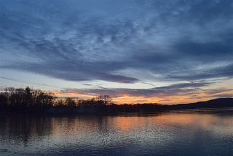 Serene Lake Sunset with Orange and Blue Cloud Reflections
