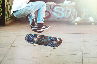 Skateboarder performing a kickflip trick in an urban setting