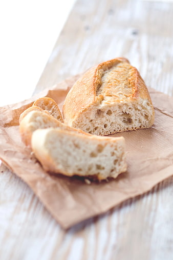 Freshly Baked Artisan Bread Slices on Brown Paper