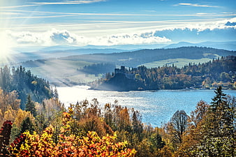 Autumn landscape with castle ruins overlooking a lake