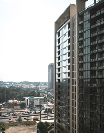 Modern High-Rise Apartment Building with City Skyline View