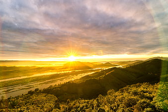 Golden Sunrise Over River Valley and Rolling Hills