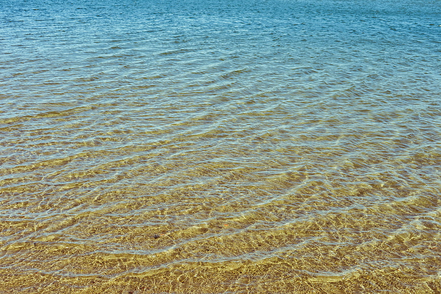 Clear Shallow Ocean Water with Sandy Bottom Texture