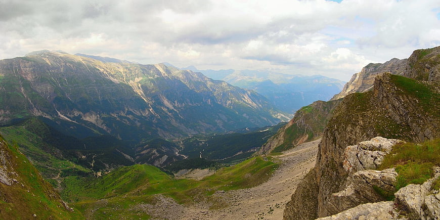 Panoramic mountain landscape with rocky peaks and green valleys