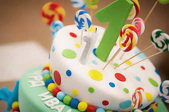 Colorful First Birthday Cake with Lollipops and Number One Candle