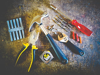 Assorted Hand Tools on Textured Workbench Surface