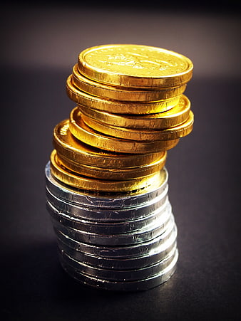 Stack of Gold and Silver Coins on Dark Background