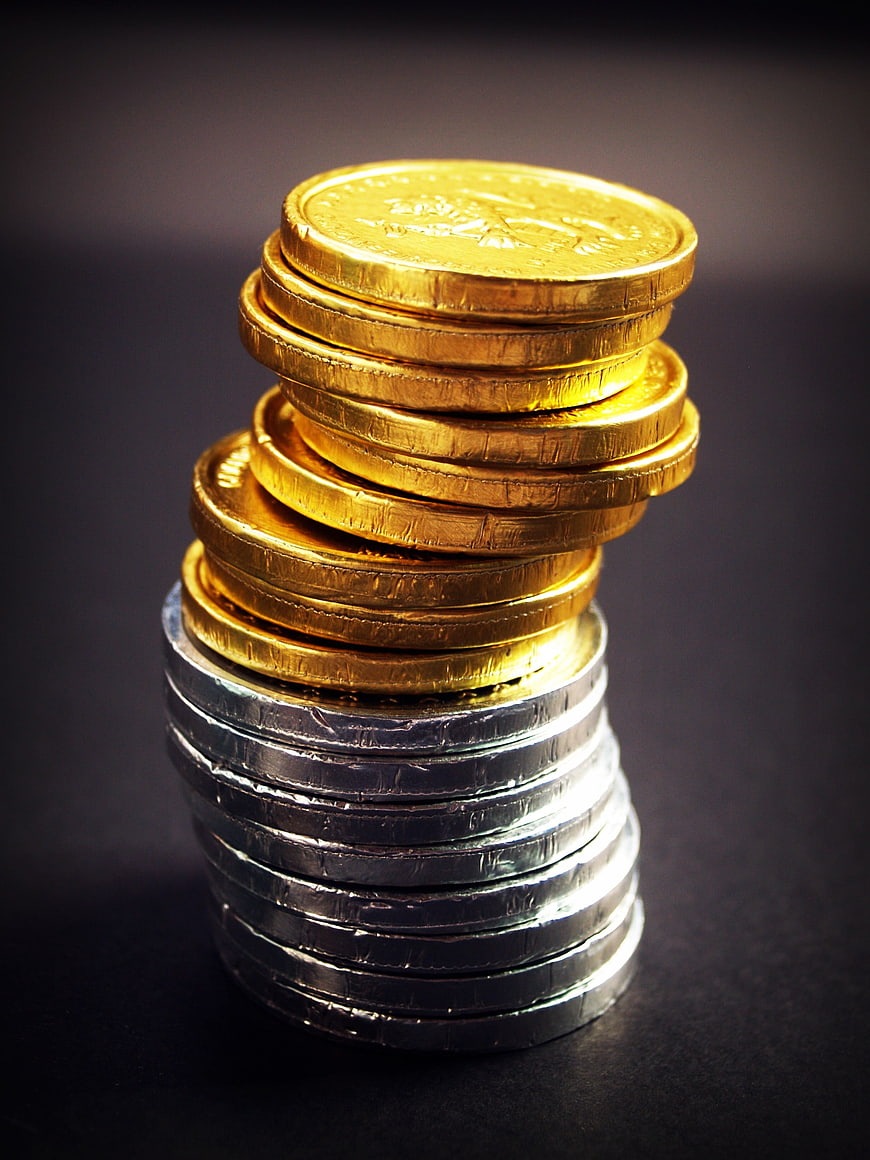 Stack of Gold and Silver Coins on Dark Background