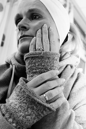 Black and white portrait of a thoughtful woman wearing a headscarf