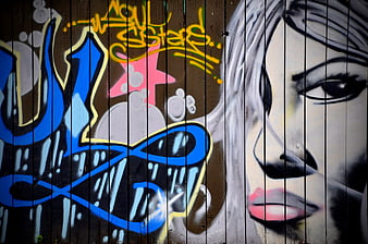 Colorful Graffiti Art on Wooden Fence with Stylized Portrait
