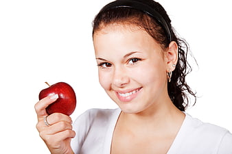 Smiling Young Woman Holding Red Apple Isolated on White
