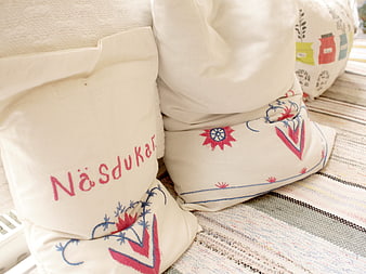 Traditional Swedish Embroidered Linen Pillows on Woven Rug