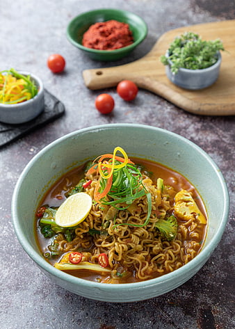 Spicy noodle soup with vegetables and garnish