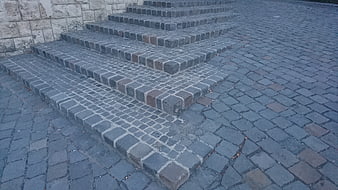 Gray cobblestone stairs and paved courtyard texture