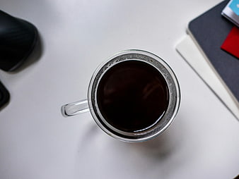 Top View of Black Coffee Cup on White Office Desk