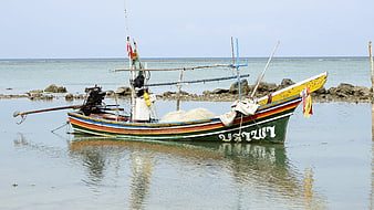 Colorful Thai Fishing Boat Anchored in Calm Shallow Waters