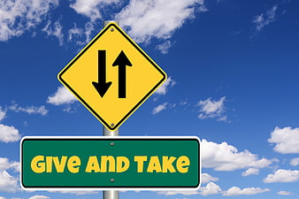 Give and Take Traffic Sign Concept Against Blue Sky