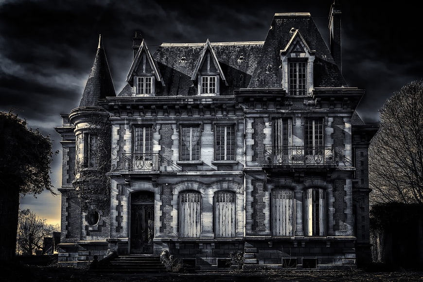 Abandoned Haunted Mansion with Dark Stormy Sky