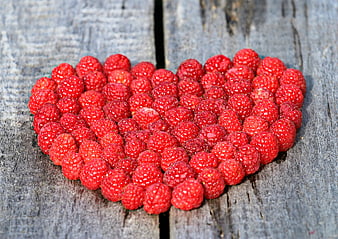 Heart Shape Made of Fresh Raspberries on Wooden Background