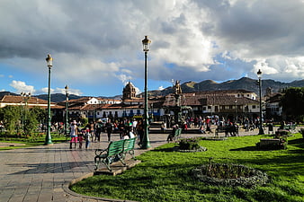 Plaza de Armas in Cusco, Peru with people and mountains