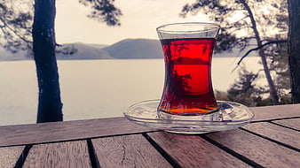 Turkish Tea in Glass Cup on Wooden Table by Lake