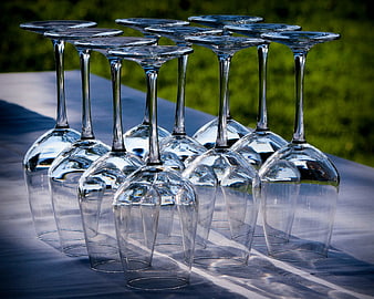 Empty wine glasses arranged on a table outdoors